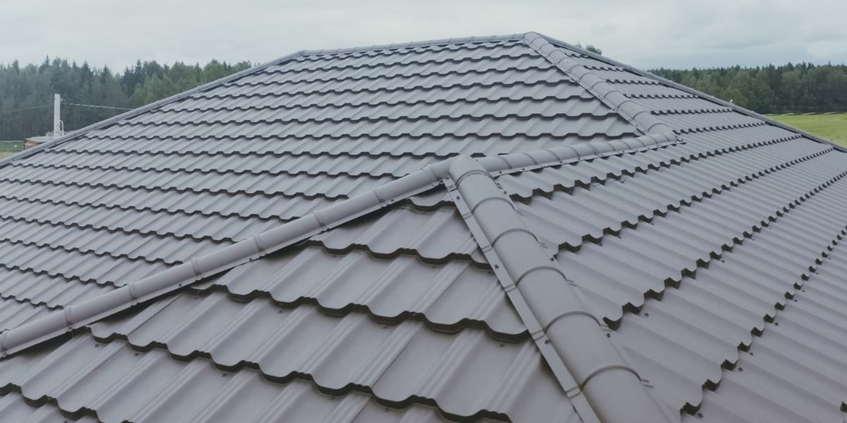 Close-up of a grey metal roofing system with interlocking panels.