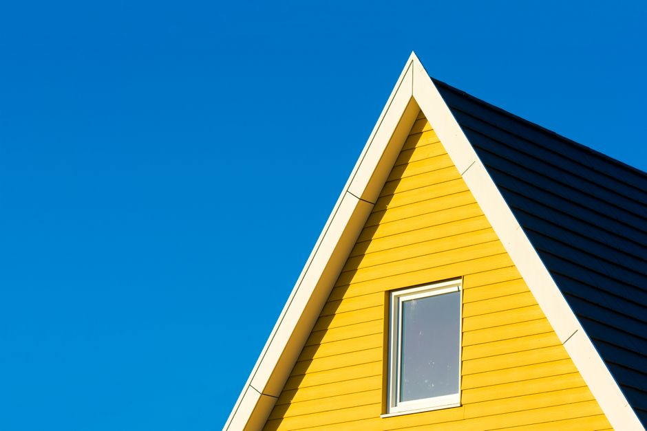 The clean, modern exterior of a suburban home in a neighborhood like those in Columbus, Indiana, on a bright, sunny day, representing an ideal property listing.