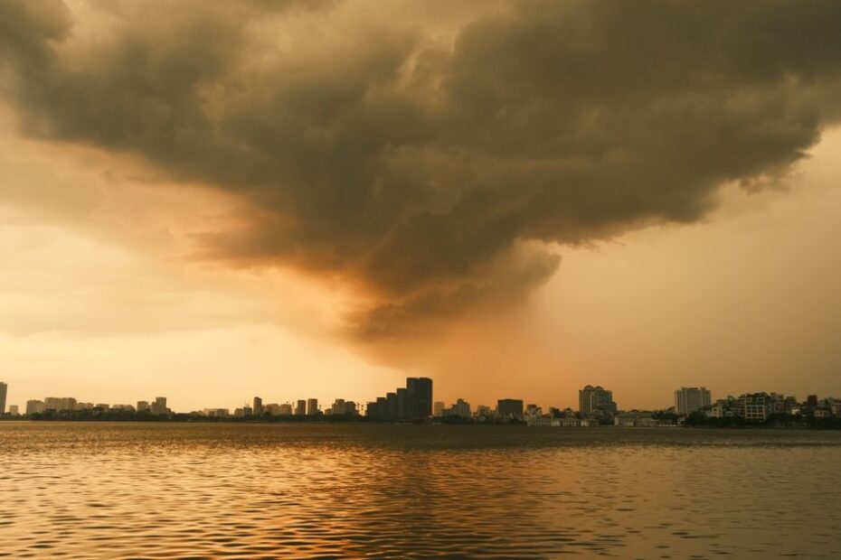 Dark, dramatic storm clouds gathering over a modern commercial building on the Gulf Coast, symbolizing the weather risks t...