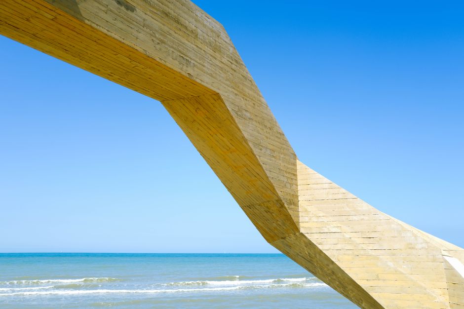 A sleek, modern commercial building stands strong under a clear blue sky on the Gulf Coast, representing a well-protected and valuable property asset.